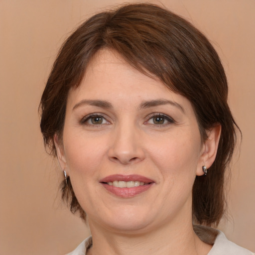 Joyful white adult female with medium  brown hair and brown eyes