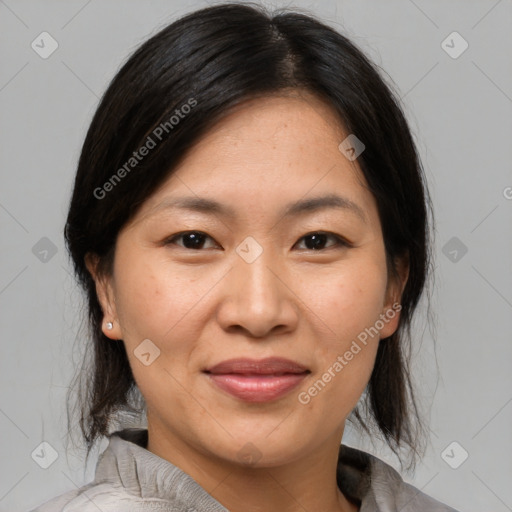 Joyful asian adult female with medium  brown hair and brown eyes