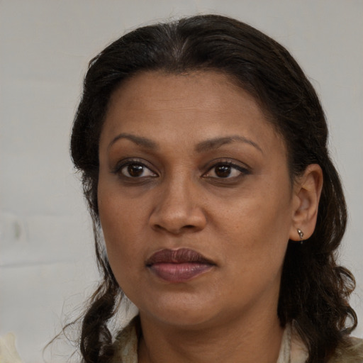 Joyful black adult female with medium  brown hair and brown eyes