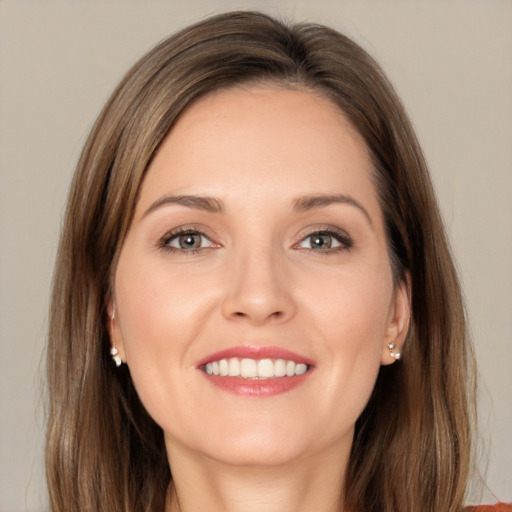 Joyful white young-adult female with long  brown hair and brown eyes