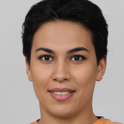 Joyful latino young-adult female with short  brown hair and brown eyes