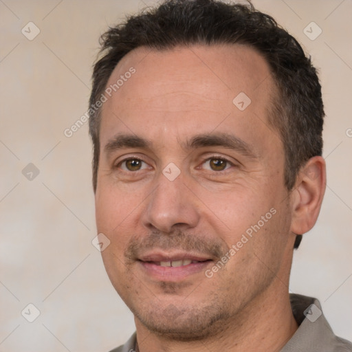 Joyful white adult male with short  brown hair and brown eyes