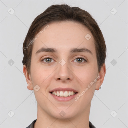 Joyful white young-adult female with short  brown hair and grey eyes