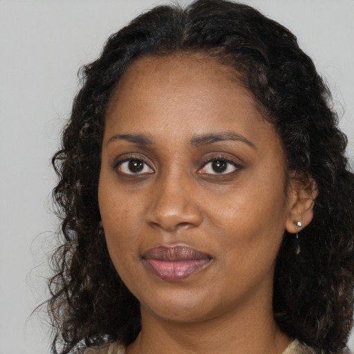Joyful black young-adult female with medium  brown hair and brown eyes