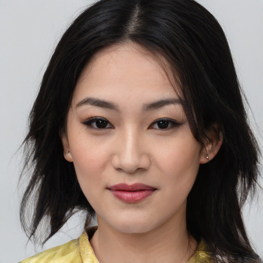 Joyful asian young-adult female with medium  black hair and brown eyes