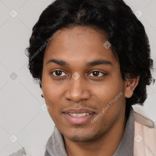 Joyful black young-adult male with short  brown hair and brown eyes