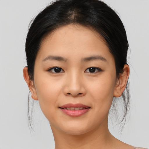 Joyful asian young-adult female with medium  brown hair and brown eyes