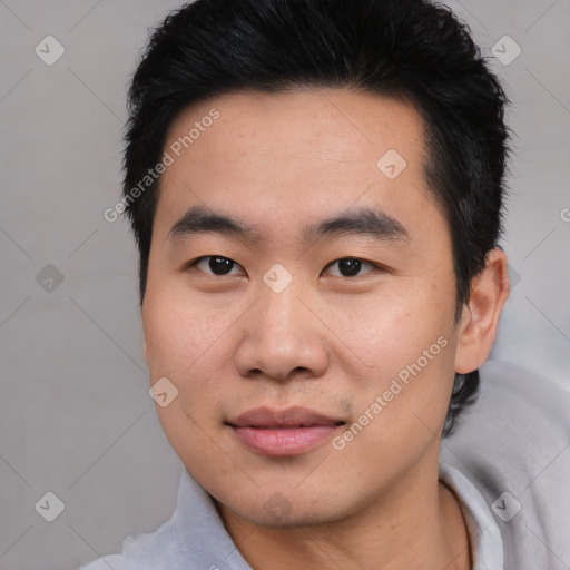 Joyful asian young-adult male with short  black hair and brown eyes