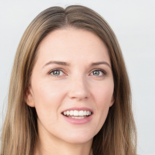 Joyful white young-adult female with long  brown hair and grey eyes