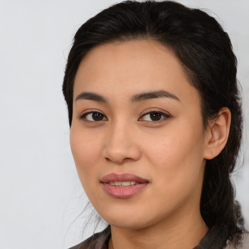 Joyful white young-adult female with medium  black hair and brown eyes
