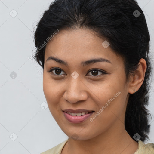 Joyful latino young-adult female with medium  brown hair and brown eyes