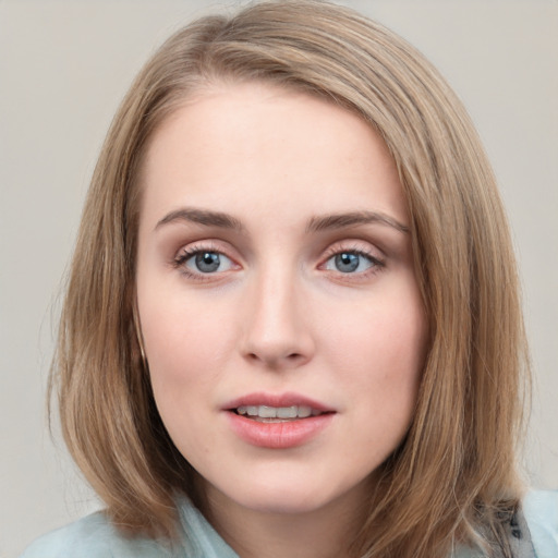 Joyful white young-adult female with medium  brown hair and blue eyes