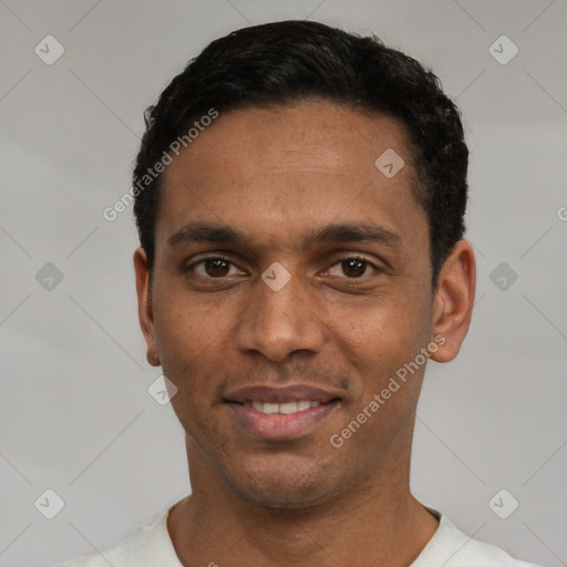 Joyful white young-adult male with short  black hair and brown eyes