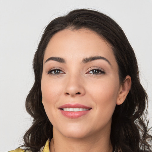 Joyful white young-adult female with long  brown hair and brown eyes