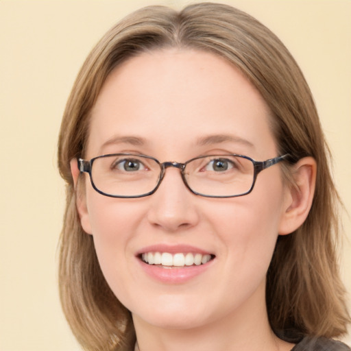 Joyful white young-adult female with medium  brown hair and green eyes