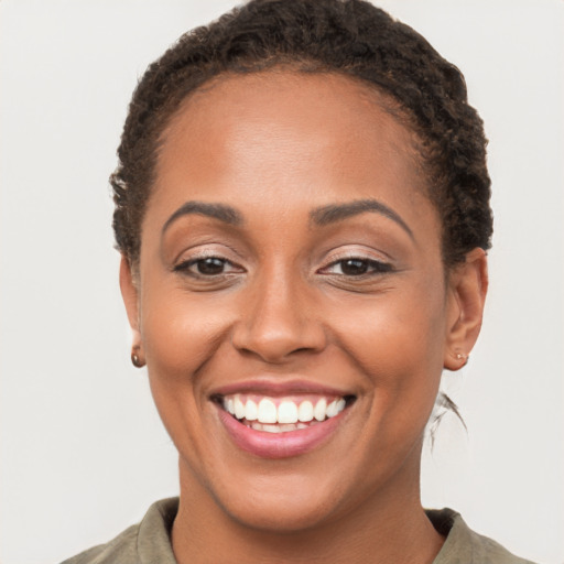 Joyful latino young-adult female with short  brown hair and brown eyes