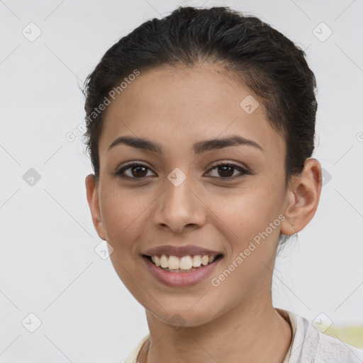 Joyful latino young-adult female with short  brown hair and brown eyes