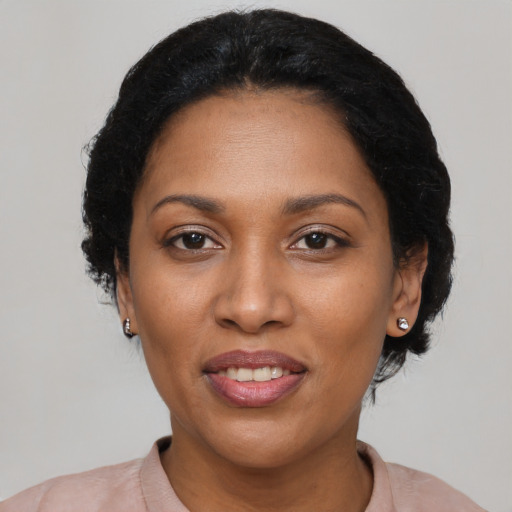Joyful black adult female with short  black hair and brown eyes