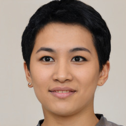 Joyful asian young-adult female with short  black hair and brown eyes