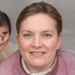 Joyful white adult female with medium  brown hair and blue eyes