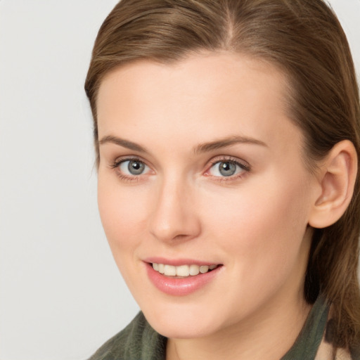 Joyful white young-adult female with long  brown hair and grey eyes