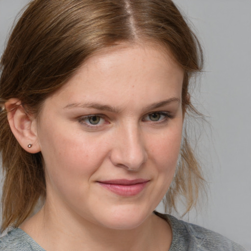 Joyful white young-adult female with medium  brown hair and blue eyes