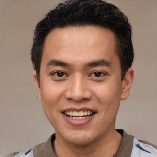 Joyful white young-adult male with short  black hair and brown eyes