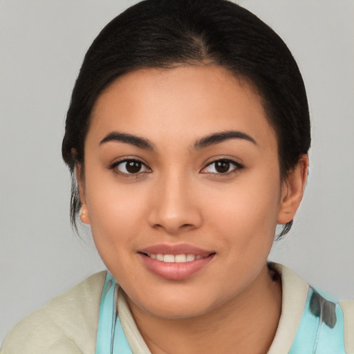 Joyful latino young-adult female with medium  brown hair and brown eyes