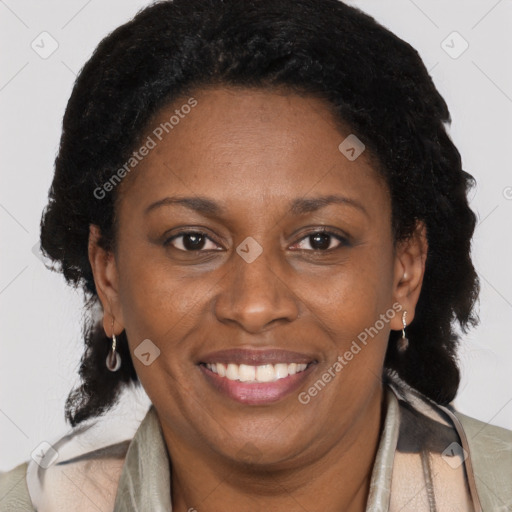 Joyful black adult female with medium  brown hair and brown eyes