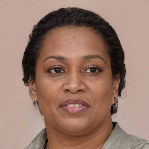 Joyful black adult female with short  brown hair and brown eyes