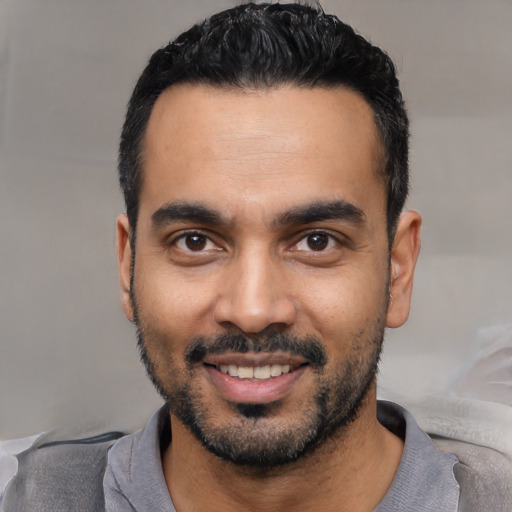 Joyful latino young-adult male with short  black hair and brown eyes