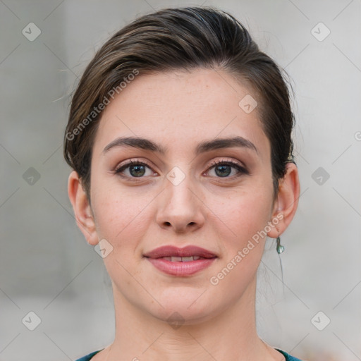 Joyful white young-adult female with medium  brown hair and grey eyes