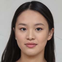 Joyful asian young-adult female with long  brown hair and brown eyes