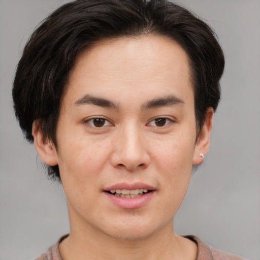 Joyful asian young-adult male with short  brown hair and brown eyes