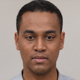 Neutral latino young-adult male with short  black hair and brown eyes
