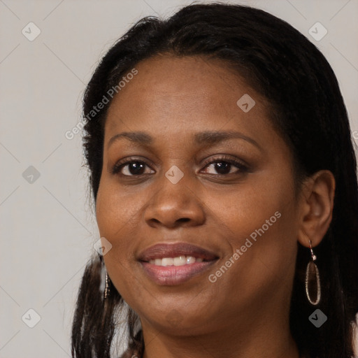 Joyful black adult female with long  brown hair and brown eyes