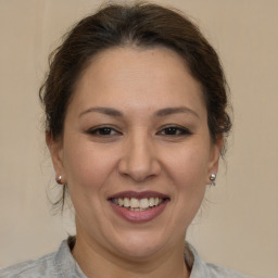 Joyful white adult female with medium  brown hair and brown eyes