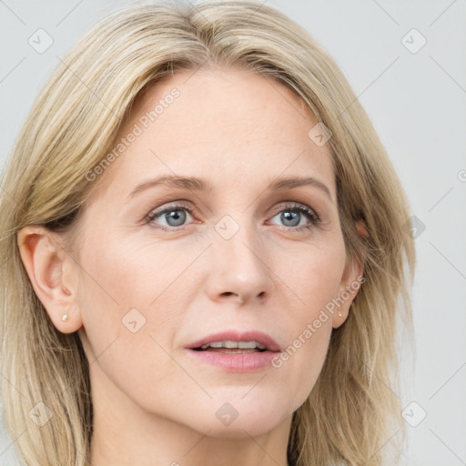 Joyful white adult female with long  brown hair and blue eyes