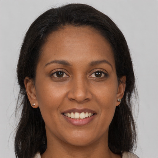 Joyful black young-adult female with medium  brown hair and brown eyes