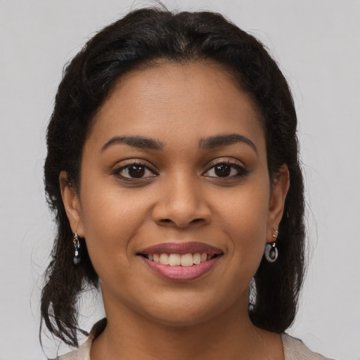 Joyful latino young-adult female with long  brown hair and brown eyes
