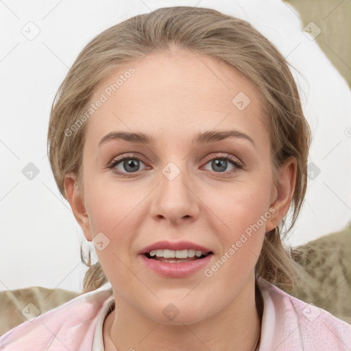 Joyful white young-adult female with medium  brown hair and blue eyes