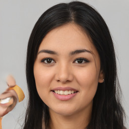 Joyful asian young-adult female with long  brown hair and brown eyes