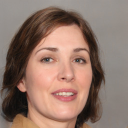 Joyful white young-adult female with medium  brown hair and blue eyes