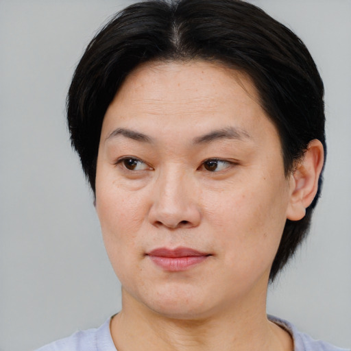 Joyful asian young-adult female with short  brown hair and brown eyes