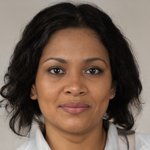 Joyful black adult female with medium  brown hair and brown eyes