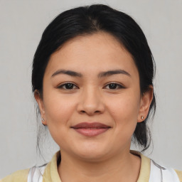 Joyful latino young-adult female with medium  brown hair and brown eyes