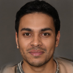 Joyful latino young-adult male with short  brown hair and brown eyes