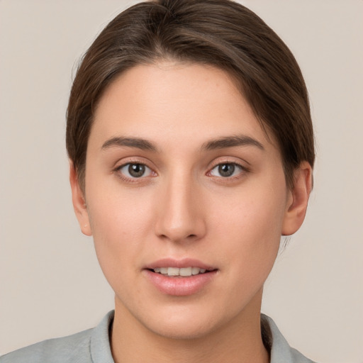 Joyful white young-adult female with short  brown hair and brown eyes