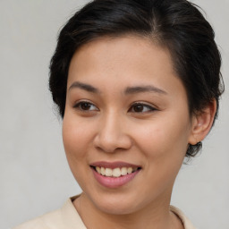 Joyful asian young-adult female with medium  brown hair and brown eyes