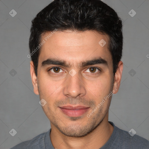 Joyful white young-adult male with short  black hair and brown eyes